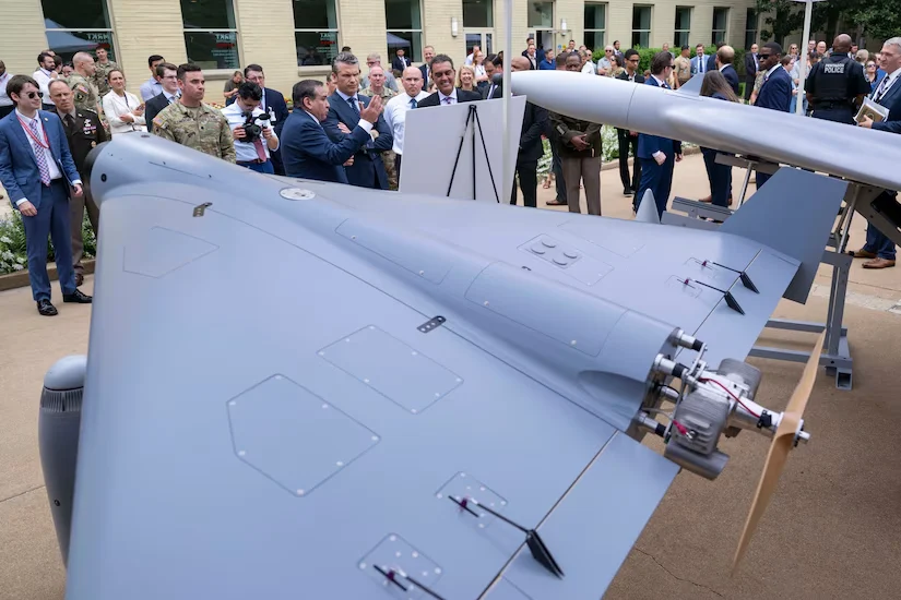 Attendees look over a drone on display at the Pentagon