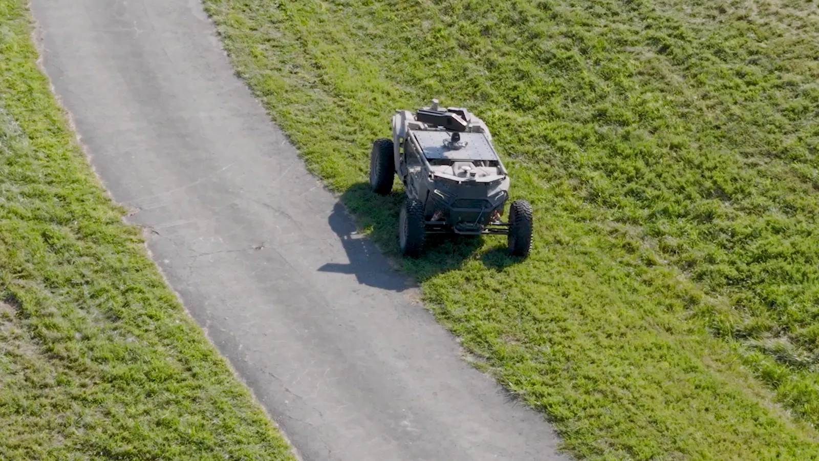 Aerial view of an uncrewed ground vehicle on a paved path